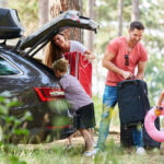 Children,Help,Parents,Carry,Luggage,To,The,Car,Before,Traveling