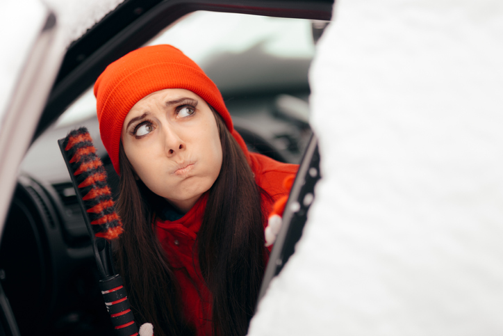 Girl Holding Snow Brush Scraper Ready to Clean the Car