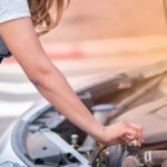 Closeup,Young,Woman,Reparing,The,Car,Under,The,Hood.,Broken