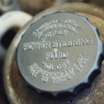 Old worn cap of power steering reservoir