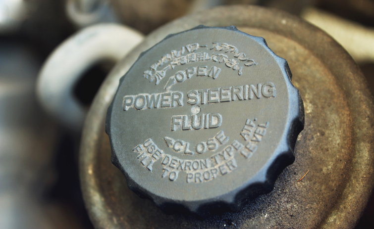 Old worn cap of power steering reservoir