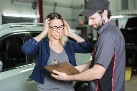 auto mechanic and female customer in garage