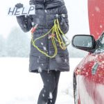 Cute woman driver needs help on the snowy road